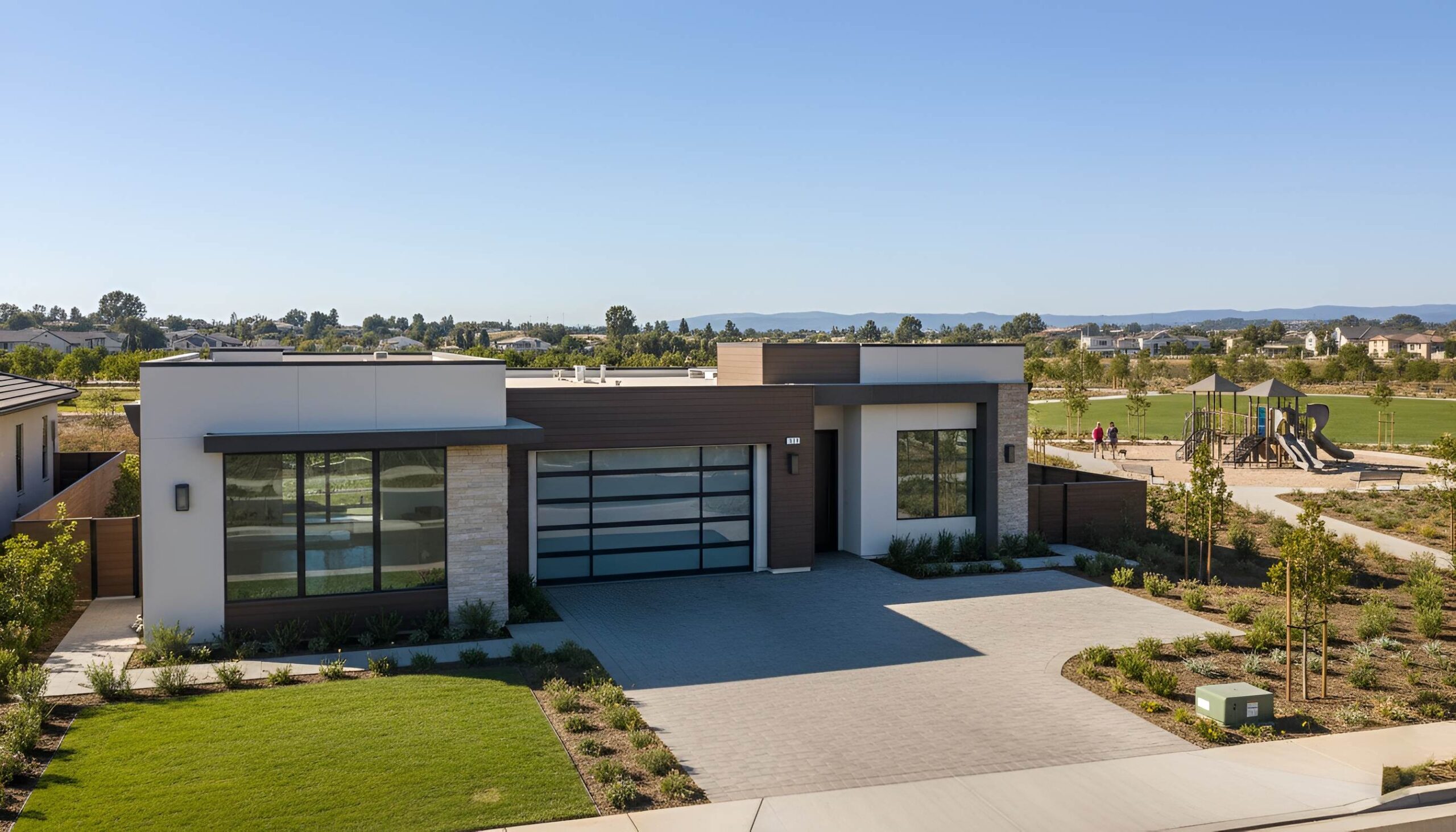 California real estate house with glass garage door and green yard