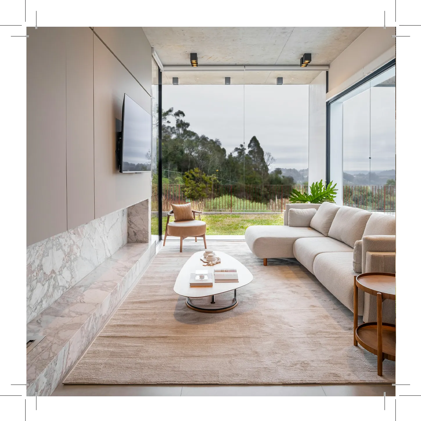 Living room with gray sofa, coffee table, TV, and big windows