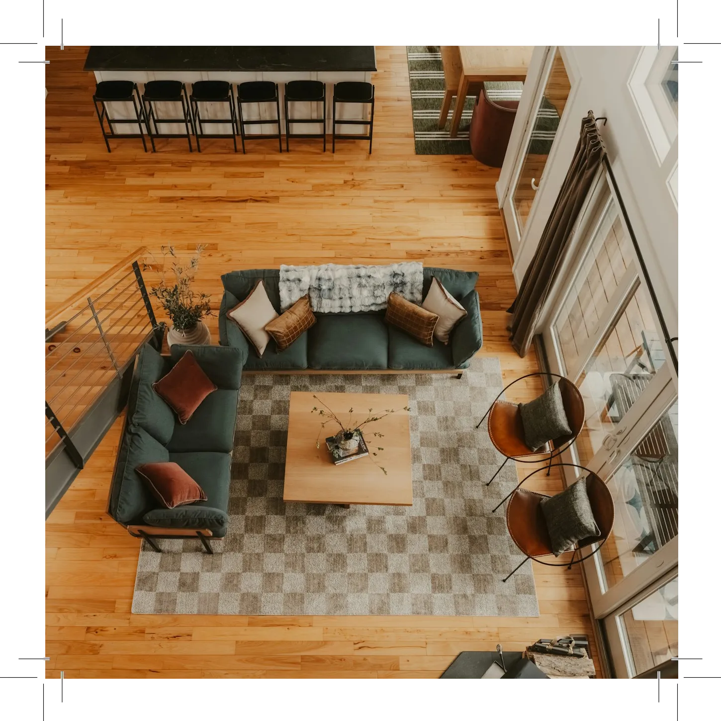 Living room with green sofa, coffee table, and hanging chairs